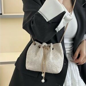 Woven Drawstring Crossbody Bag in Cream